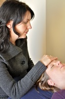 Gallery Photo of Dr. Raina Lasse providing craniosacral therapy to reduce stress and improve sleep.