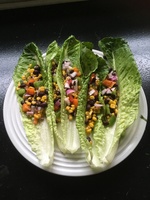 Gallery Photo of Black bean and veggies salad served on lettuce leaves to boost your intake of vitamins and minerals